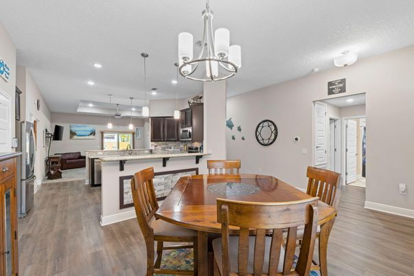 Chandelier, Dining room, Interior, Kitchen, Pendant Lights, Recessed Lighting, Stainless Steel Appliances, Wood Texture Flooring