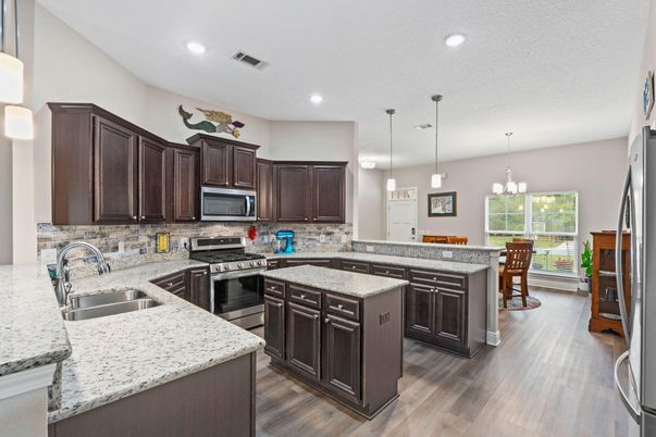 Chandelier, Dining room, Interior, Kitchen, Pendant Lights, Recessed Lighting, Stainless Steel Appliances, Wood Texture Flooring
