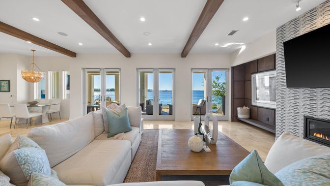 Chandelier, Dining room, Fireplace, Interior, Living room, Recessed Lighting, Stone Walls, Water, Wooden Beams, Wood Texture Flooring