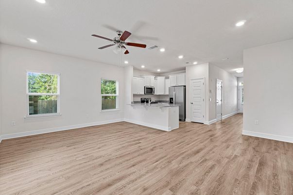 Empty room, Interior, Kitchen, Recessed Lighting, Stainless Steel Appliances, Wood Texture Flooring