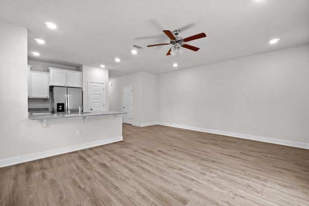 Empty room, Interior, Kitchen, Recessed Lighting, Stainless Steel Appliances, Wood Texture Flooring