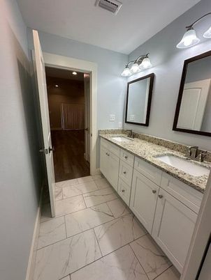Bathroom, Dual Sink Vanities, Interior, Marble, Recessed Lighting, Wood Texture Flooring