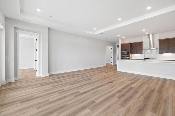 Empty room, Interior, Kitchen, Recessed Lighting, Stainless Steel Appliances, Wood Texture Flooring