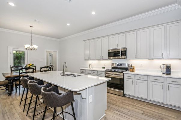 Chandelier, Dining room, Interior, Kitchen, Recessed Lighting, Stainless Steel Appliances, Wood Texture Flooring