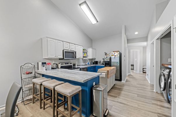 Interior, Kitchen, Recessed Lighting, Washer, Wood Texture Flooring