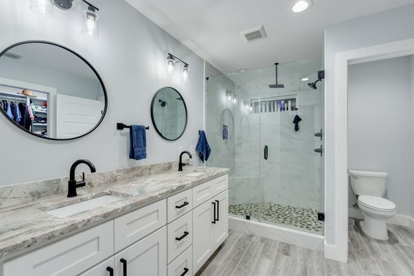 Bathroom, Dual Sink Vanities, Glass Shower, Interior, Marble Walls, Recessed Lighting, Wood Texture Flooring