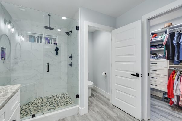 Bathroom, Glass Shower, Interior, Marble Walls, Recessed Lighting, Walk-in Closets, Wood Texture Flooring