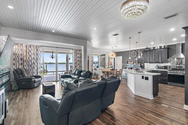 Chandelier, Dining room, Interior, Kitchen, Living room, Pendant Lights, Recessed Lighting, Stainless Steel Appliances, Water, Wood Texture Flooring