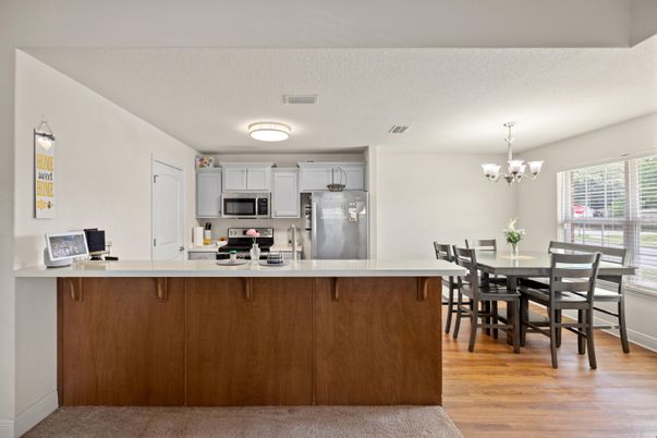 Chandelier, Dining room, Interior, Kitchen, Stainless Steel Appliances, Wood Texture Flooring