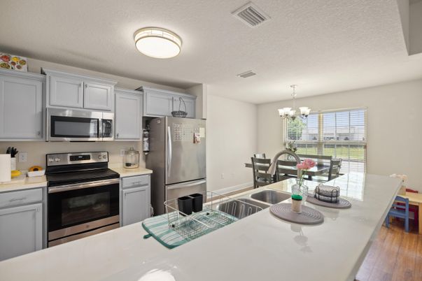 Chandelier, Dining room, Interior, Kitchen, Stainless Steel Appliances, Wood Texture Flooring