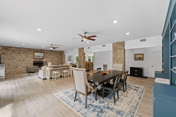 Dining room, Fireplace, Interior, Living room, Recessed Lighting, Stone Walls, Wood Texture Flooring