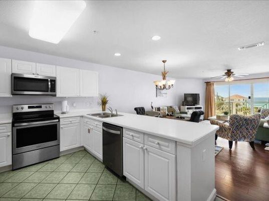 Chandelier, Dining room, Interior, Kitchen, Living room, Recessed Lighting, Stainless Steel Appliances, Water, Wood Texture Flooring