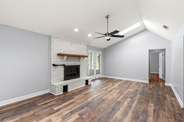 Empty room, Fireplace, Interior, Recessed Lighting, Stone Walls, Wood Texture Flooring