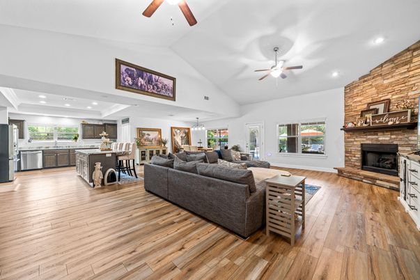 Dining room, Fireplace, Interior, Kitchen, Living room, Recessed Lighting, Stone Walls, Wood Texture Flooring