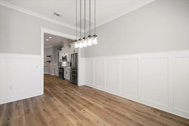 Empty room, Interior, Kitchen, Pendant Lights, Recessed Lighting, Stainless Steel Appliances, Wood Texture Flooring