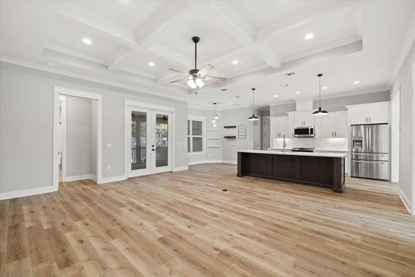 Empty room, Interior, Kitchen, Pendant Lights, Recessed Lighting, Stainless Steel Appliances, Wood Texture Flooring