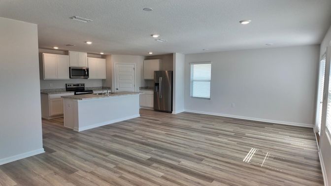 Empty room, Interior, Kitchen, Recessed Lighting, Stainless Steel Appliances, Wood Texture Flooring