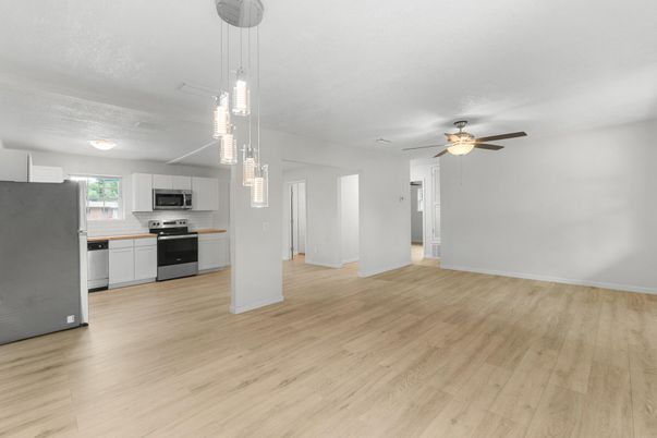 Empty room, Interior, Kitchen, Pendant Lights, Stainless Steel Appliances, Wood Texture Flooring