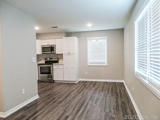 Empty room, Interior, Kitchen, Recessed Lighting, Stainless Steel Appliances, Wood Texture Flooring
