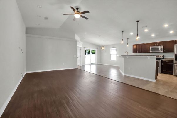 Empty room, Interior, Kitchen, Pendant Lights, Recessed Lighting, Stainless Steel Appliances, Wood Texture Flooring