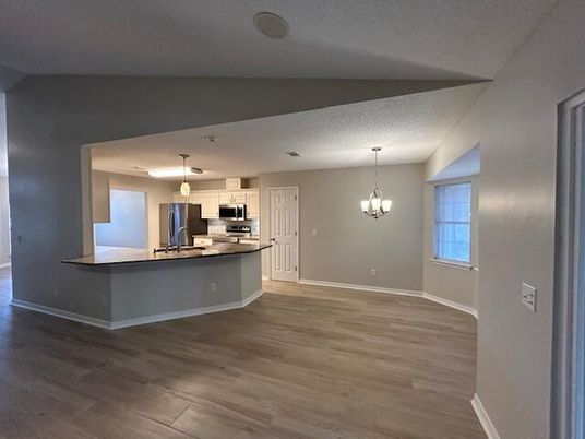 Chandelier, Empty room, Interior, Kitchen, Pendant Lights, Stainless Steel Appliances, Wood Texture Flooring