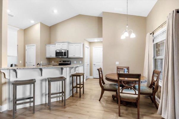Dining room, Interior, Kitchen, Pendant Lights, Recessed Lighting, Stainless Steel Appliances, Wood Texture Flooring