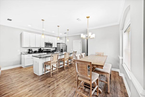 Chandelier, Dining room, Interior, Kitchen, Pendant Lights, Recessed Lighting, Stainless Steel Appliances, Wood Texture Flooring