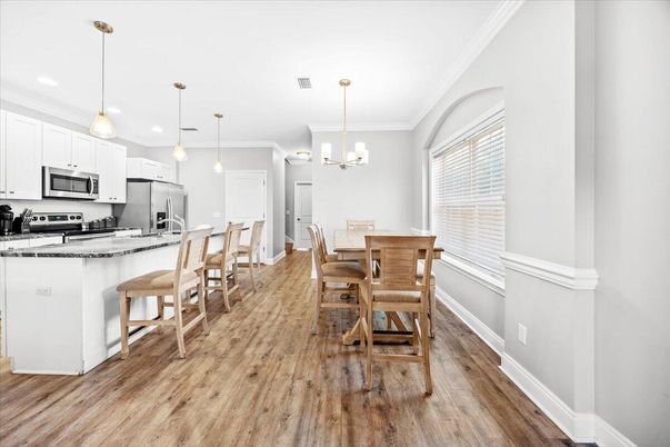 Dining room, Interior, Kitchen, Pendant Lights, Recessed Lighting, Stainless Steel Appliances, Wood Texture Flooring