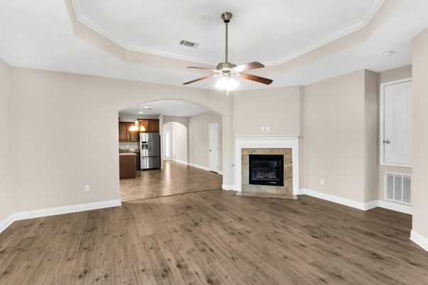 Empty room, Fireplace, Interior, Kitchen, Recessed Lighting, Stainless Steel Appliances, Wood Texture Flooring