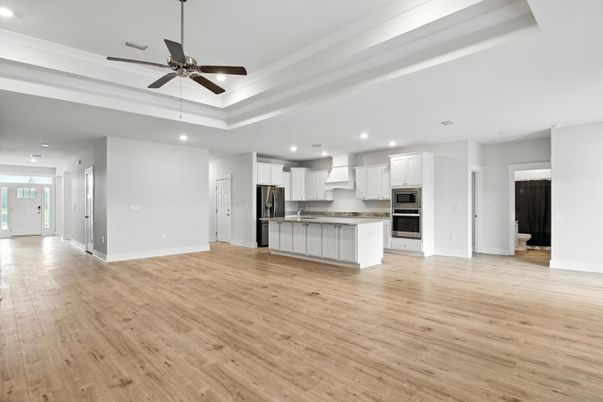 Empty room, Interior, Kitchen, Recessed Lighting, Stainless Steel Appliances, Wood Texture Flooring