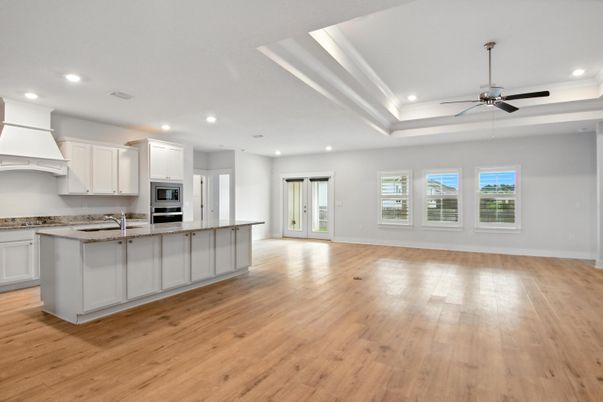 Empty room, Interior, Kitchen, Recessed Lighting, Stainless Steel Appliances, Wood Texture Flooring