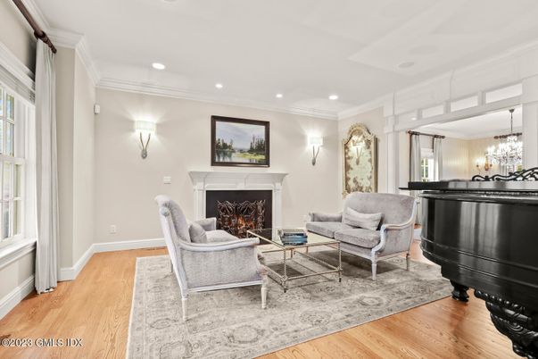 Chandelier, Fireplace, Interior, Living room, Piano, Recessed Lighting, Wood Texture Flooring
