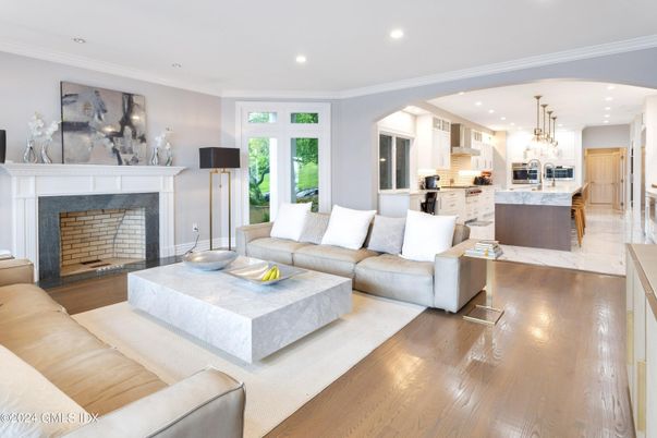 Chandelier, Fireplace, Interior, Kitchen, Living room, Marble, Recessed Lighting, Stainless Steel Appliances, Wood Texture Flooring