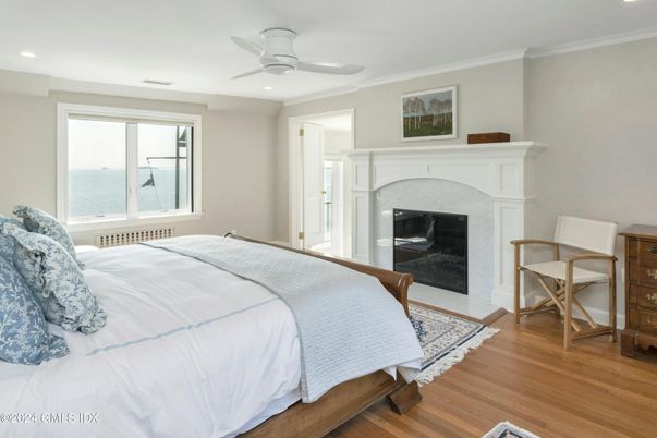Bedroom, Fireplace, Interior, Recessed Lighting, Water, Wood Texture Flooring