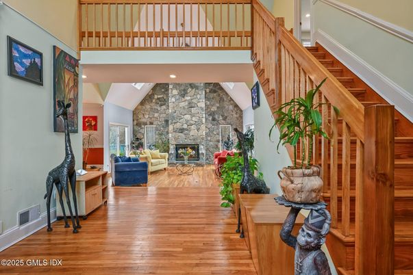 Fireplace, Interior, Living room, Recessed Lighting, Stone Walls, Wood Texture Flooring