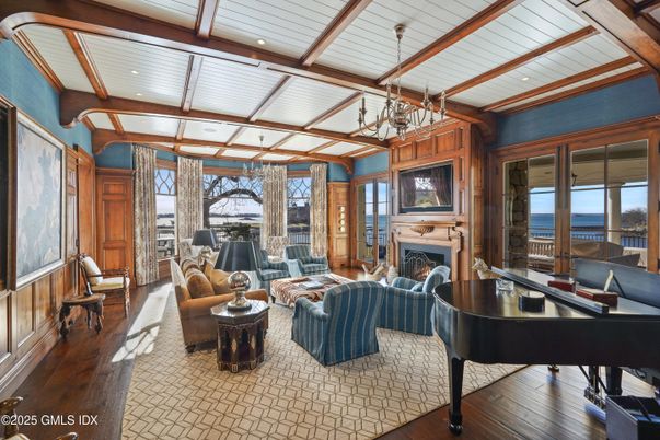 Chandelier, Fireplace, Interior, Living room, Piano, Recessed Lighting, Water, Wooden Beams, Wood Texture Flooring