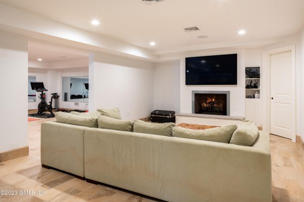 Fireplace, Fitness Equipment, Interior, Living room, Recessed Lighting, Wood Texture Flooring