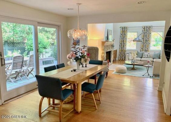 Chandelier, Dining room, Fireplace, Interior, Living room, Pendant Lights, Recessed Lighting, Wood Texture Flooring
