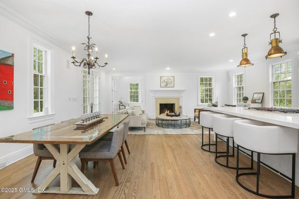 Chandelier, Dining room, Fireplace, Interior, Living room, Pendant Lights, Recessed Lighting, Wood Texture Flooring