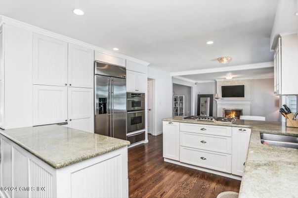 Fireplace, Interior, Kitchen, Recessed Lighting, Stainless Steel Appliances, Wood Texture Flooring