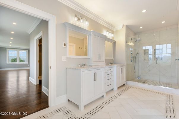 Bathroom, Dual Sink Vanities, Glass Shower, Interior, Marble Walls, Recessed Lighting, Wood Texture Flooring