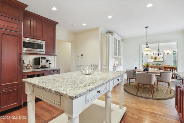 Chandelier, Dining room, Interior, Kitchen, Pendant Lights, Recessed Lighting, Stainless Steel Appliances, Wood Texture Flooring