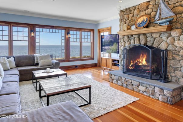 Fireplace, Interior, Living room, Recessed Lighting, Stone Walls, Water, Wood Texture Flooring