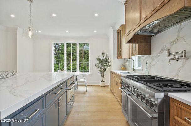 Interior, Kitchen, Marble Walls, Pendant Lights, Recessed Lighting, Stainless Steel Appliances, Wood Texture Flooring