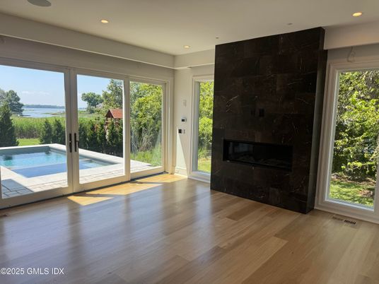 Empty room, Fireplace, Interior, Recessed Lighting, Water, Wood Texture Flooring