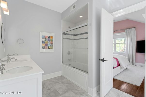 Bathroom, Dual Sink Vanities, Glass Shower, Interior, Marble, Recessed Lighting, Wood Texture Flooring