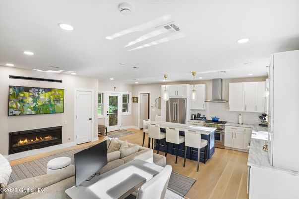 Fireplace, Interior, Kitchen, Living room, Pendant Lights, Recessed Lighting, Stainless Steel Appliances, Wood Texture Flooring