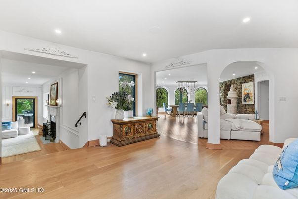 Dining room, Fireplace, Interior, Living room, Recessed Lighting, Stone Walls, Wood Texture Flooring