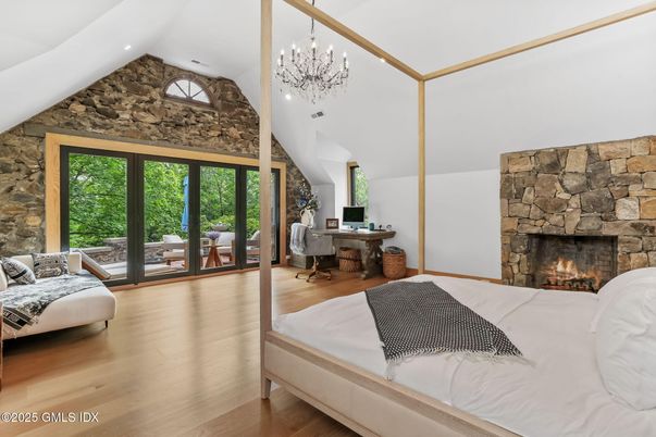 Bedroom, Chandelier, Fireplace, Interior, Recessed Lighting, Stone Walls, Wood Texture Flooring