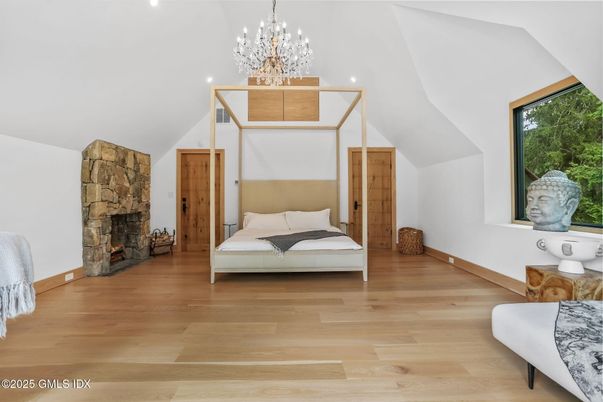 Bedroom, Chandelier, Fireplace, Interior, Recessed Lighting, Wood Texture Flooring